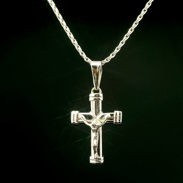 Silver crucifix pendant on a chain against a black background